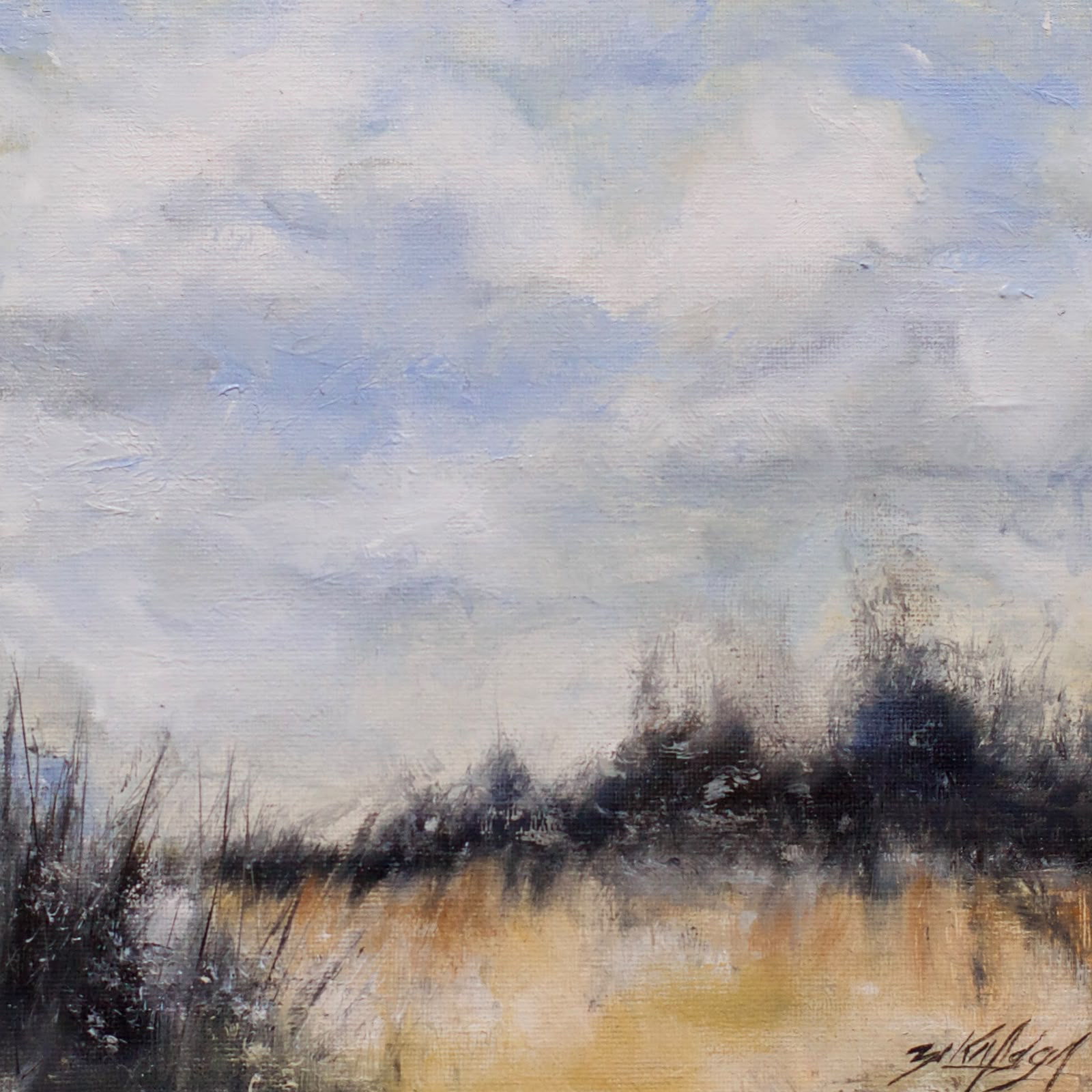 Landscape with a pale blue sky, dark vegetation and a golden field