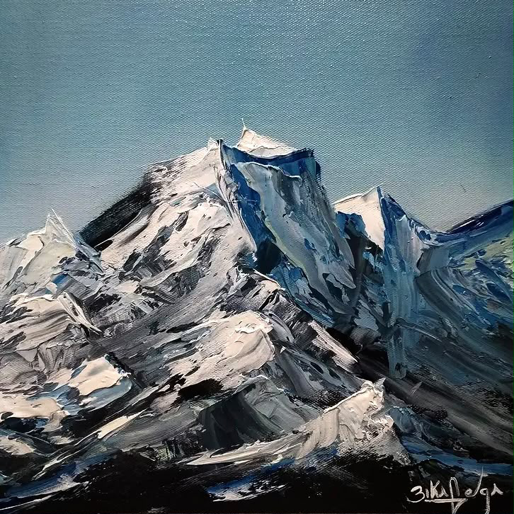 Snowy mountains beneath a blue sky